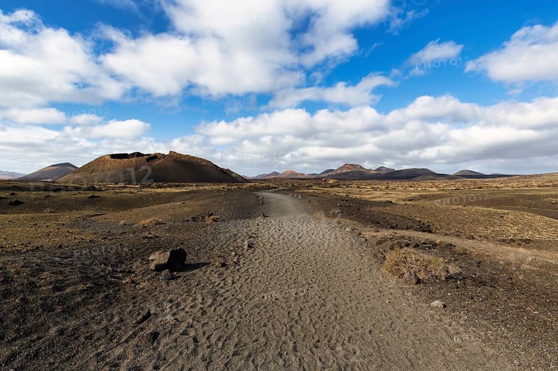 Hiking trail to the volcanic crater Caldera de Los Cuervos, lava fields, Los Volcanes nature park Park, Tias, Yaiza, Lanzarote, Spain, Europe