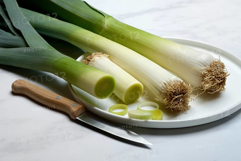 Leek, leek sticks on plate with knife, leek