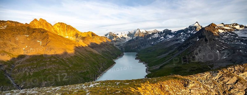 Picturesque mountain landscape at the summit Mont de la Blana at sunset, view of blue mountain lake, reservoir Lac des Dix and summit Mont Blanc de Cheilon with glacier, Hérémence, Valais, Western Alps, Switzerland, Europe