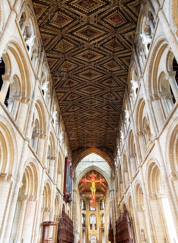 Interior of cathedral church, Peterborough, Cambridgeshire, England, UK looking up at ceiling and sculpture of Jesus Christ on Cross