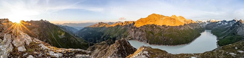 Panorama, Picturesque mountain landscape at the summit Mont de la Blana at sunset, view of blue mountain lake, reservoir Lac des Dix and summit Mont Blanc de Cheilon with glacier, Sun Star, Hérémence, Valais, Western Alps, Switzerland, Europe