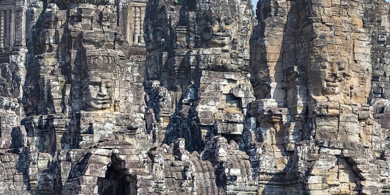 Panoramic image of giant stone-carved faces of the Bodhisattva Lokeshvara, also known as Avalokiteshvara, Bayon Temple, Angkor Thom, UNESCO World Heritage Site, Angkor Wat, Siem Reap, Cambodia, Asia