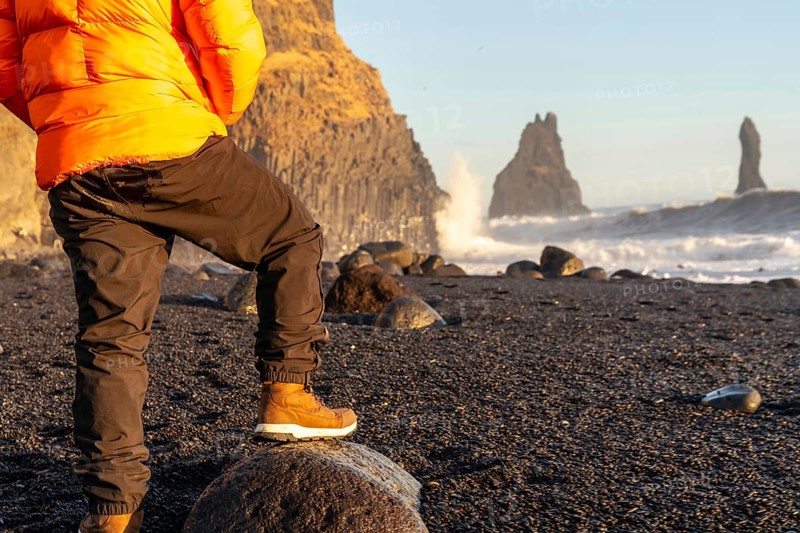 Unrecognizable person on the beautiful Reynisfjara Black Sand Beach in Iceland in winter