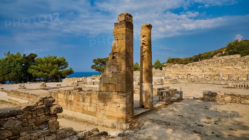 Two ancient stone columns stand in the middle of a ruined site under a slightly cloudy sky, Kamiros, Archaeological site, Ancient city, Foundation of Doric Greeks, Rhodes, Dodecanese, Greek Islands, Greece, Europe
