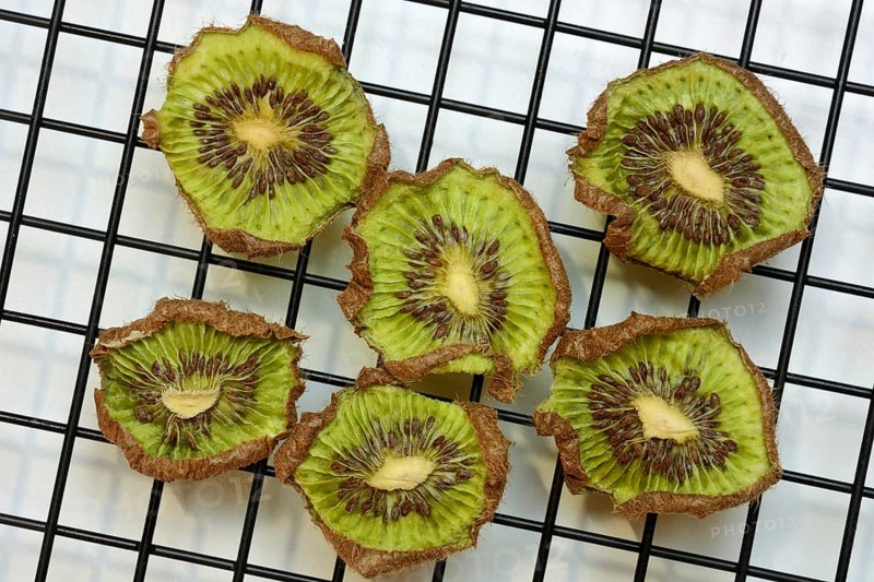 Dried kiwi slices on a wire rack, dried fruit