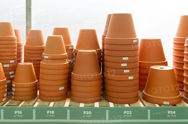 Variety of sizes of clay flower pots on display in at Swanns Nursery garden centre, Suffolk, England, UK