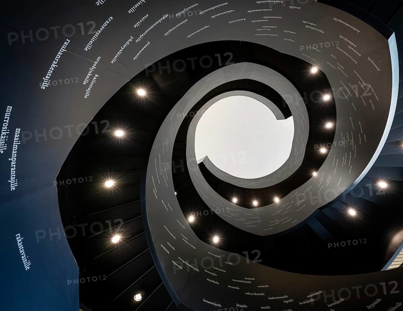 Spiral staircase printed with Finnish words, Oodi Central Library and Cultural Centre, designed by ALA Architects, Helsinki, Finland, Europe