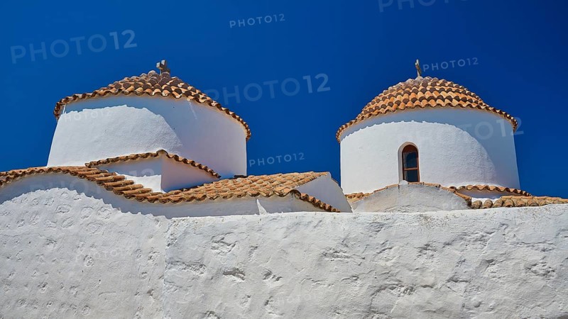 Two white painted church towers with red tiled roofs and small windows, bright blue sky, Chora, Old Town, Patmos, Dodecanese, Greek Islands, Greece, Europe