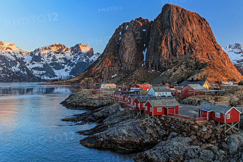 Typical Norwegian houses in fjord in front of steep mountains, morning light, winter, Reine, Moskenesoya, Lofoten, Norway, Europe