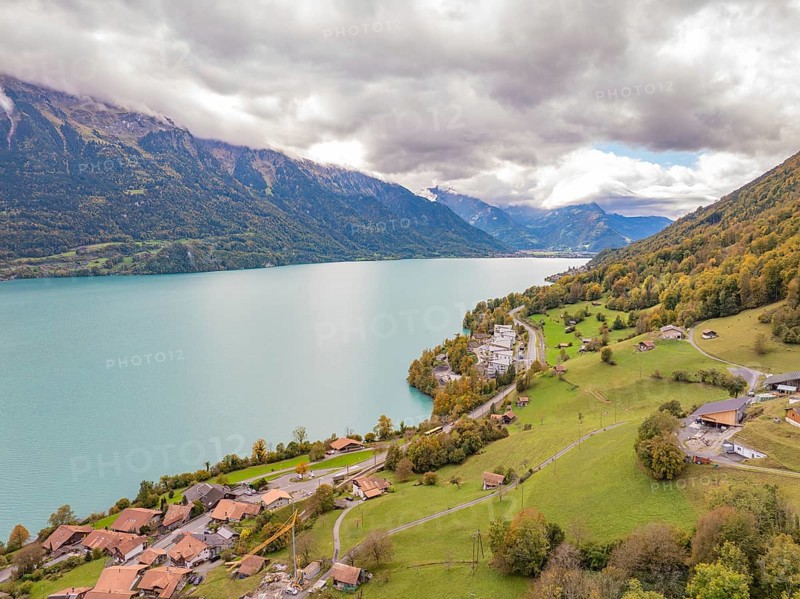Sweeping views over a large lake with surrounding mountains, villages and meadows, Lake Brienz. Switzerland