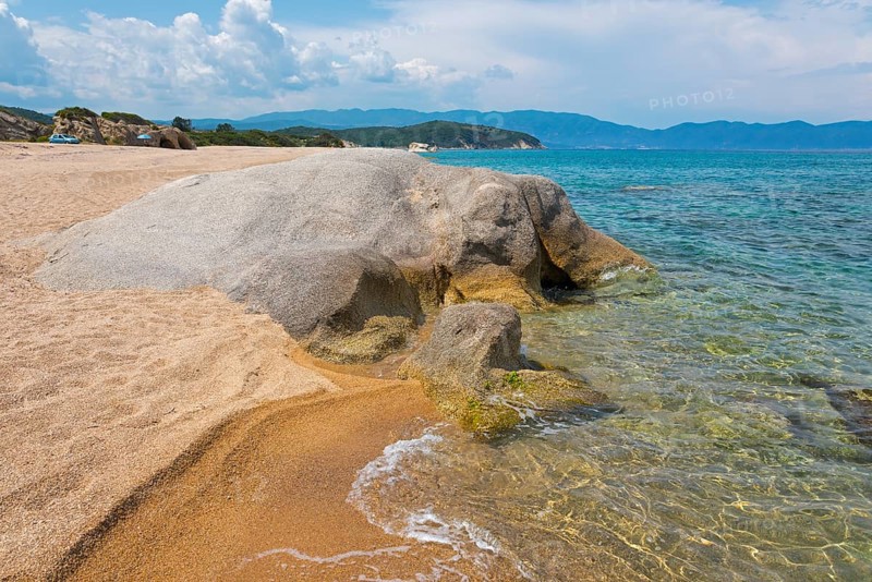 Rocky beach with clear sea water and gentle waves, surrounded by nature, beach, rocks in the shape of an elephant, Kakoudia, Ierissos, Sithonia, Halkidiki, Central Macedonia, Greece, Europe
