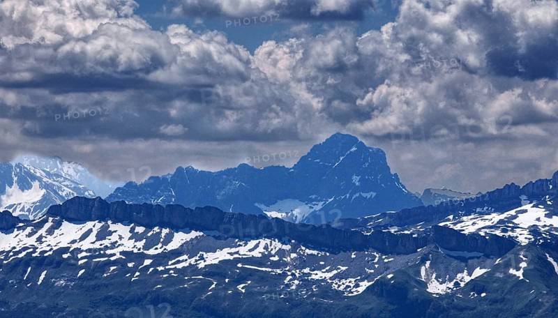 View of impressive mountain range with snow-covered peaks under dramatic clouds, Oberstaufen, Bavaria, Germany, Europe