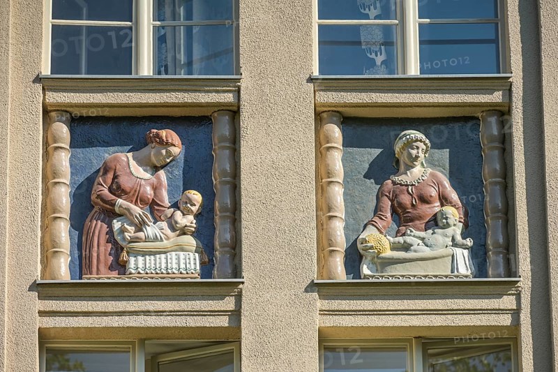 Mothers looking after their babies, relief on an old building, former woman's and children's clinic, today St. Marien residential park, Mariendorfer Weg, Neukölln, Berlin, Germany, Europe