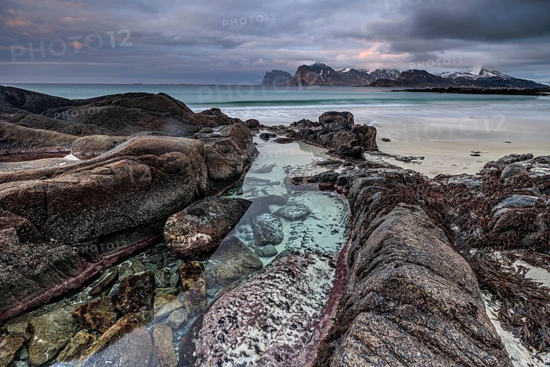 Rocks and beach in front of Bergen, sea, surf, spray, clouds, winter, Flakstadoya, Lofoten, Norway, Europe
