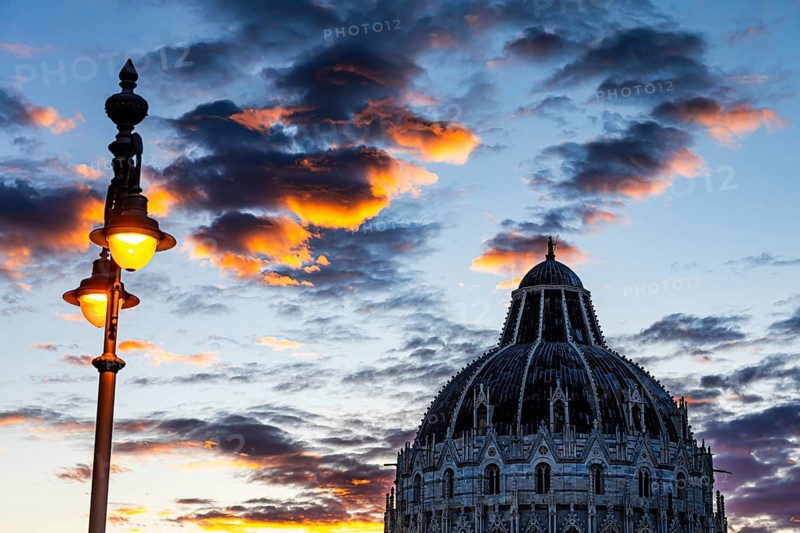 Baptistery chapel under an illuminated street lamp at sunset, Pisa Tuscany, Italy, Europe