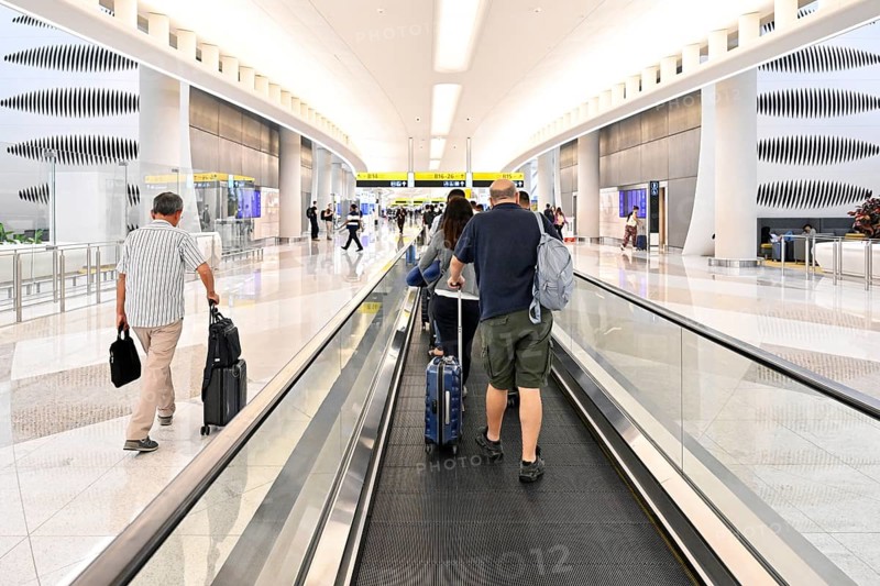 Airport transit tourists with luggage, Abu Dhabi, UAE