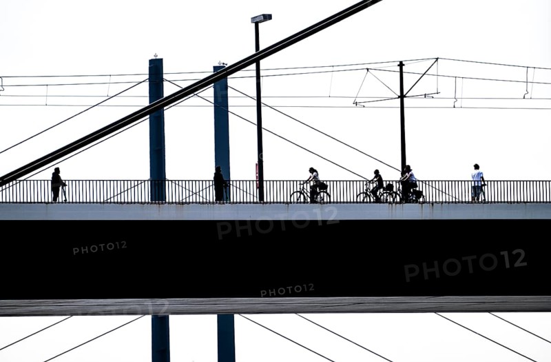 Oberkassler bridge over the Rhine near Düsseldorf, in front, behind the Rheinknie bridge, cyclist, North Rhine-Westphalia, Germany, Europe