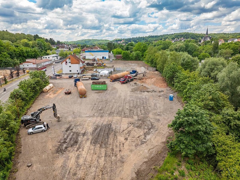 Landscape view of a large construction site in the countryside, surrounded by houses and a cloudy sky, demolition site of a former lorry transport company with oil tanks, Saarbrücken, Germany, Europe