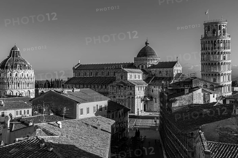 Above the roofs of Pisa, behind the Baptistery, the Cathedral of Santa Maria Assunta and the Leaning Tower, black and white photo, Pisa, Tuscany, Italy, Europe