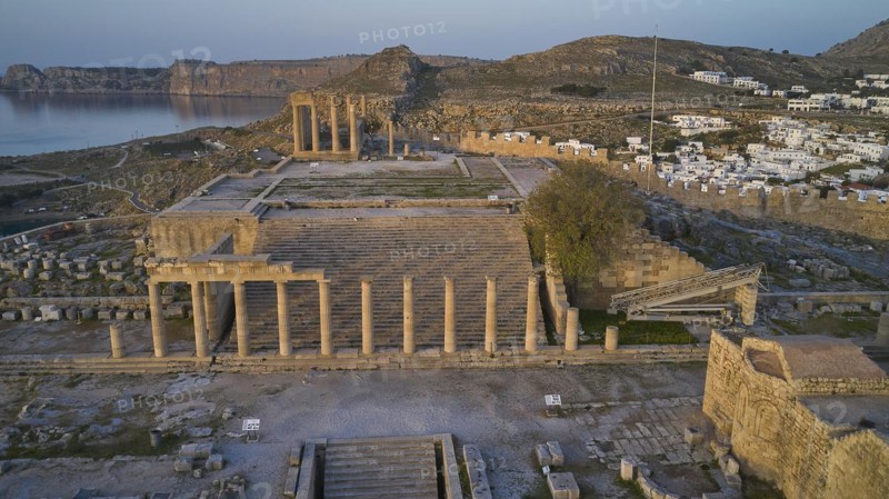 Drone shot, first morning light, Lindos, Acropolis of Lindos, Propylaea with staircase, Temple of Athena Lindia, The columns of an ancient temple, in the background mountains and blue twilight, Archaeological site, Lindos, Rhodes, Dodecanese, Greek Islands, Greece, Europe