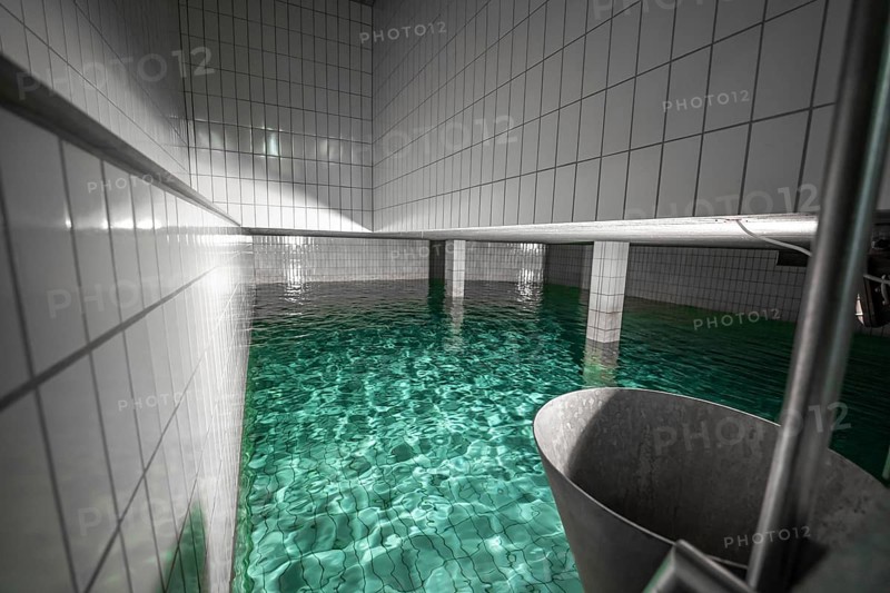 Large water basin with tiled walls and reflecting water, ENCW Netze Calw waterworks, Calw, Black Forest, Germany, Europe