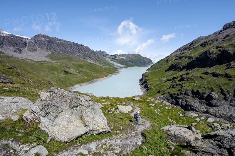 Mountaineer on hiking trail in front of Lac des Dix reservoir, Valais Alps, Valais, Switzerland, Europe
