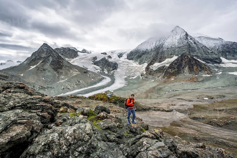 Mountaineer in front of impressive mountain landscape, mountain hut Cabane des Dix in front of glacier Glacier de Cheilon and summit Mont Blanc de Cheilon, Valais Alps, Valais, Switzerland, Europe