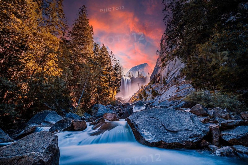 Sunset at Vernal Falls in Yosemite National Park in the water next to the stones, long exposure photo. California, United States, North America