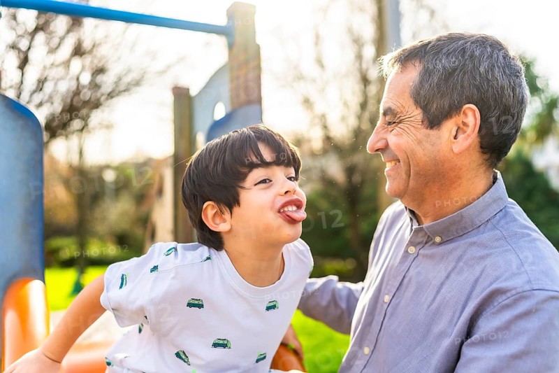 Grandfather and grandson having fun together at the playground, enjoying quality time and creating lasting memories