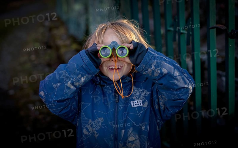 Little boy, 5 years, blond, looks through children's binoculars, toy, Stuttgart, Baden-Württemberg, Germany, Europe