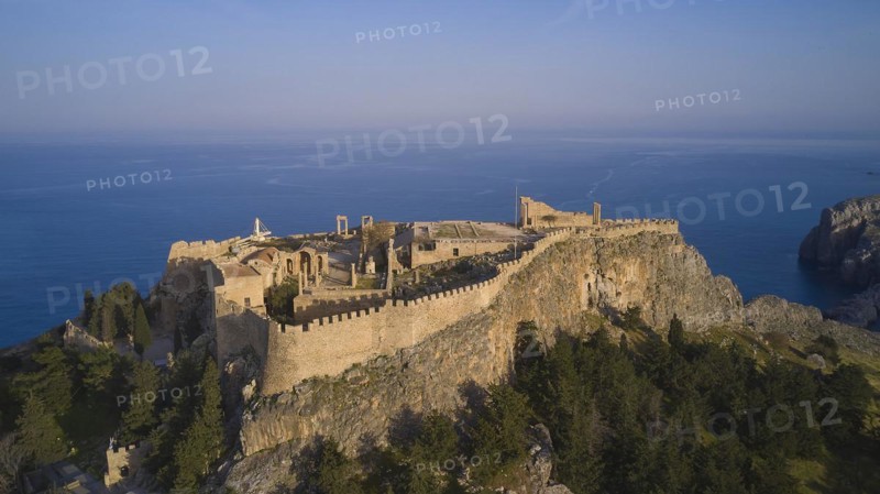 Drone shot, Acropolis of Lindos, Late afternoon light, Historic castle on a cliff above the sea in golden sunlight, Archaeological site, Lindos, Rhodes, Dodecanese, Greek Islands, Greece, Europe