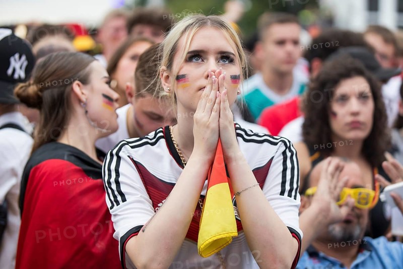 A woman watches the football match in the fan zone at the Brandenburg Tor during the quarter-final match between Germany and Spain at the European Football Championship, Berlin, 05/07/2024