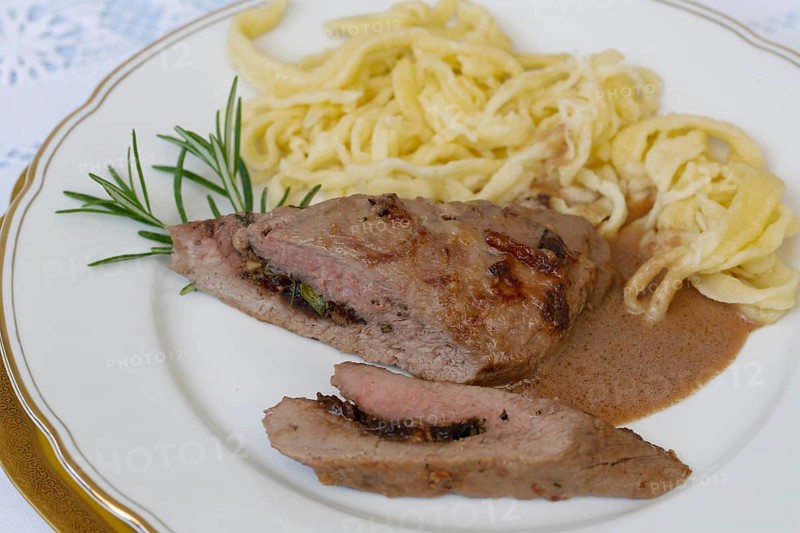 Swabian cuisine, lamb stuffed with prunes, rosemary, herbs, fillets arranged on plates, hand-scraped spaetzle, gravy, grandmother's cooking, regional, home cooking, typical Swabian, traditional cuisine reinterpreted, food photography, studio, Germany, Europe