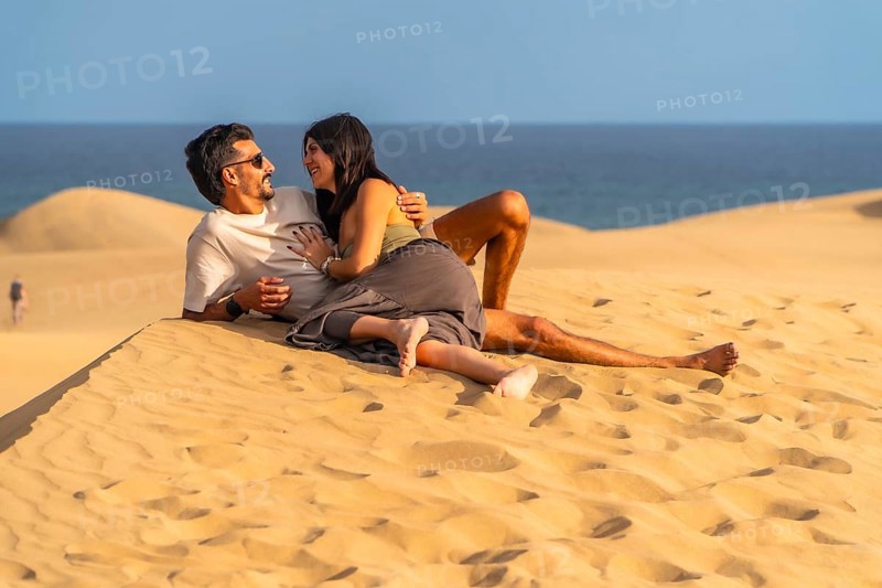 Tourists enjoying summer holidays lying on the sand in the maspalomas dunes, gran canaria, canary islands, spain