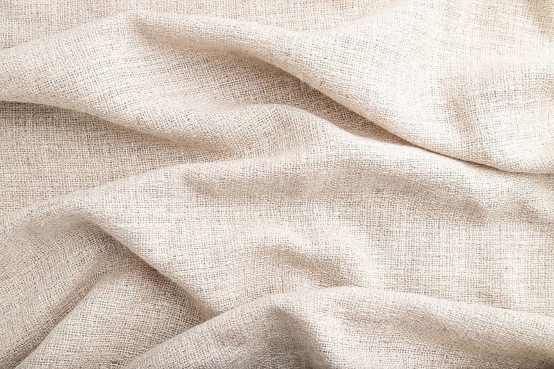 Fragment of white linen tissue. Side view, natural textile background and texture. wave concept, abstract
