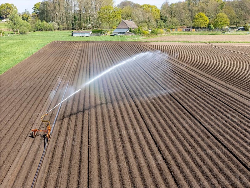 Artificial irrigation of a potato field in April, with a sprinkler system, long drought in spring makes this necessary, for the total of 7.5 hectares 3 full days are needed to get the necessary moisture for the freshly sown potato plants, south of Straelen, Lower Rhine, North Rhine-Westphalia, Germany, Europe