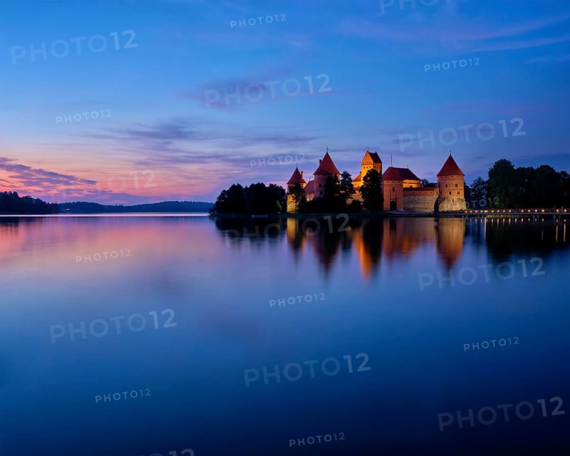 Evening view of Trakai Island Castle in lake Galve illuminated in the night, Lithuania, Europe
