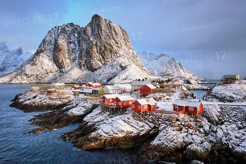 Famous tourist attraction Hamnoy fishing village on Lofoten Islands, Norway with red rorbu houses in winter