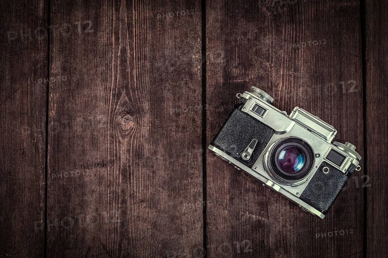 Photography concept background, old retro vintage camera on grunge wooden texture