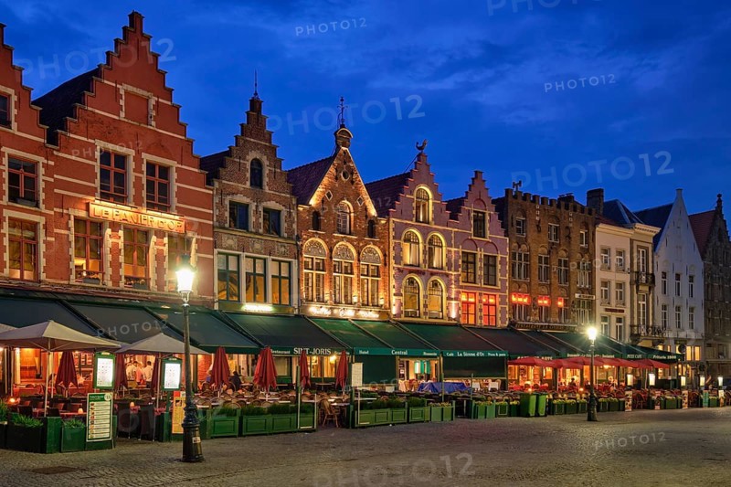 Bruges, Belgium, May 29, 2018: Bruges Grote markt square famous tourist place with many cafe and restaurants in the evening night twilight, Europe