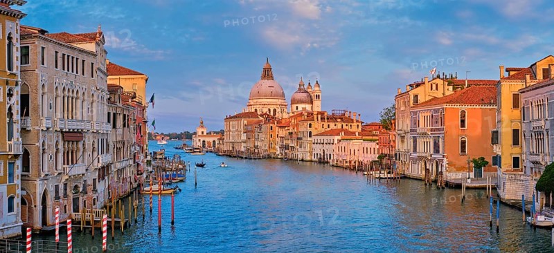 Panorama of Venice Grand Canal with boats and Santa Maria della Salute church on sunset from Ponte dell'Accademia bridge. Venice, Italy, Europe