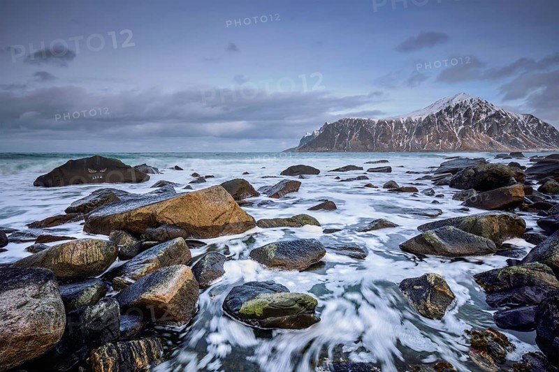 Rocky coast of fjord of Norwegian sea in winter. Skagsanden beach, Lofoten islands, Norway, Europe