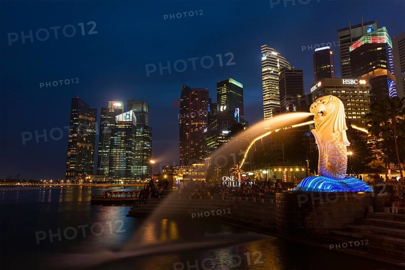 SINGAPORE, JANUARY 1, 2014: Night view of Singapore Merlion at Marina Bay against Singapore skyline. Merlion is a well-known tourist icon, mascot and national personification of Singapore