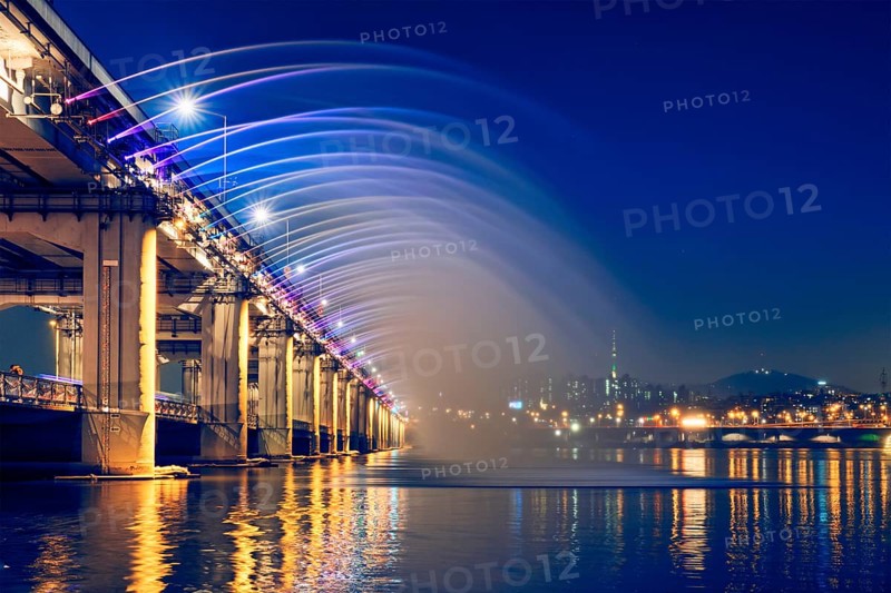 SEOUL, SOUTH KOREA, APRIL 7, 2017: Banpo Bridge Rainbow Fountain tourist landmark on Han river illuminated at night, Seoul, South Korea, Asia