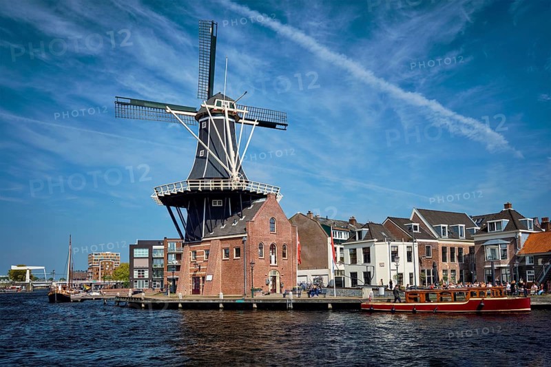 View of Harlem landmark windmill De Adriaan on Spaarne river. Harlem, Netherlands