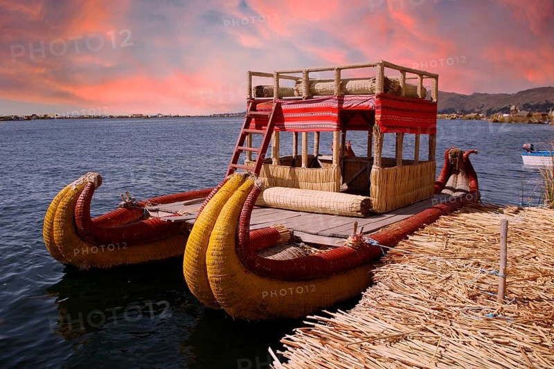 Boat used by people living on the island of Los Uros in Lake Titicaca, beautiful sunset, Peru, South America