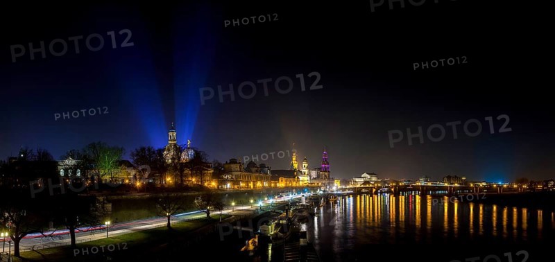 Dresden Silhouette View of the Old Town from the Carola Bridge. On the occasion of the commemoration of the 70th anniversary of the destruction of Dresden, floodlights shine into the night sky at the Church of Our Lady