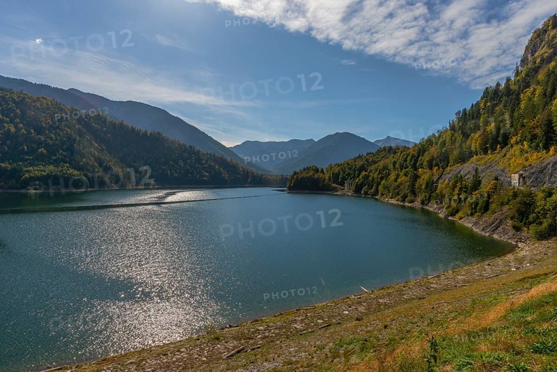 Intake structure at the Sylvenstein reservoir serves as flood protection, dams the Isar, power station, power generation, forest, driftwood on the bank, blue sky