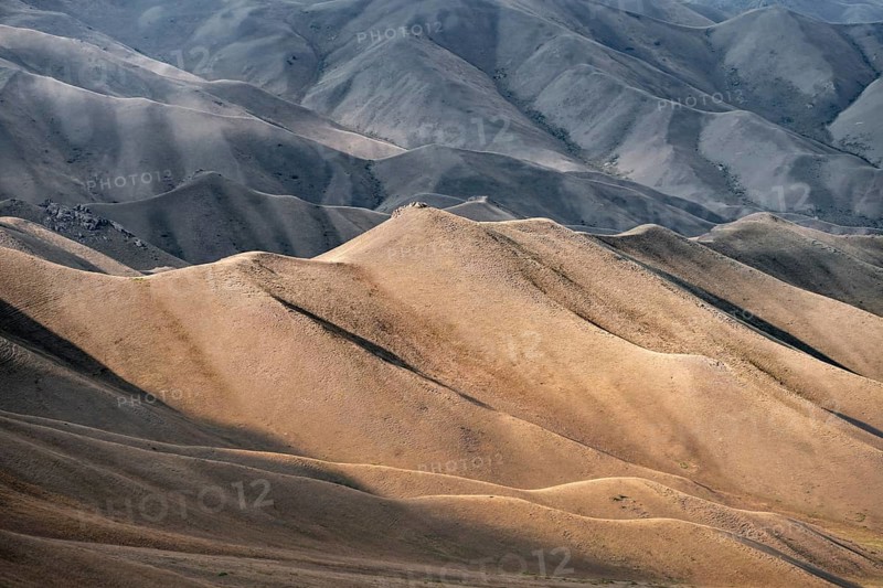 View of mountain landscape with rolling grassy hills at Tyibel Pass, Song Kul Too mountain range, Naryn region, Kyrgyzstan, Asia
