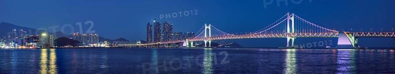 Panorama of Gwangan Bridge and skyscrapers illuminated in the night. Busan, South Korea, Asia